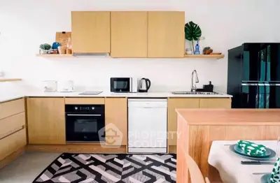 Modern kitchen with wooden cabinets, sleek appliances, and stylish decor