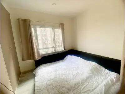 Cozy bedroom with large window and comfortable bed in modern apartment