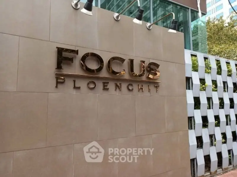 Modern building entrance with stylish signage at Focus Ploenchit.