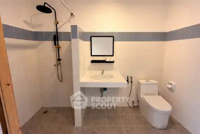 Modern minimalist bathroom with sleek fixtures and neutral tiles, perfect for a contemporary home.