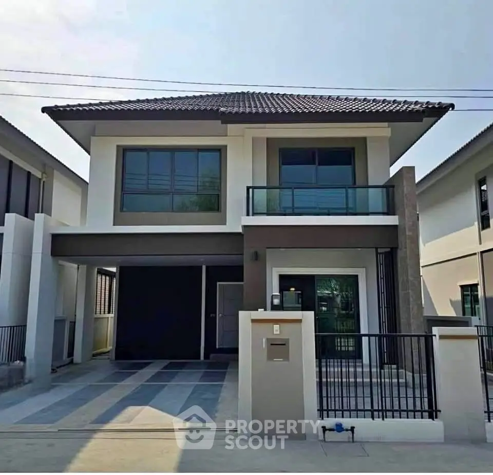 Modern two-story house with sleek design and spacious driveway