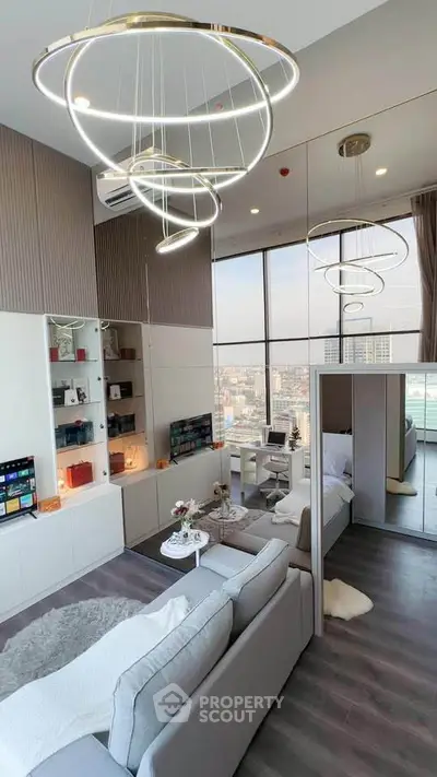 Luxurious modern living room with floor-to-ceiling windows and elegant lighting fixtures.