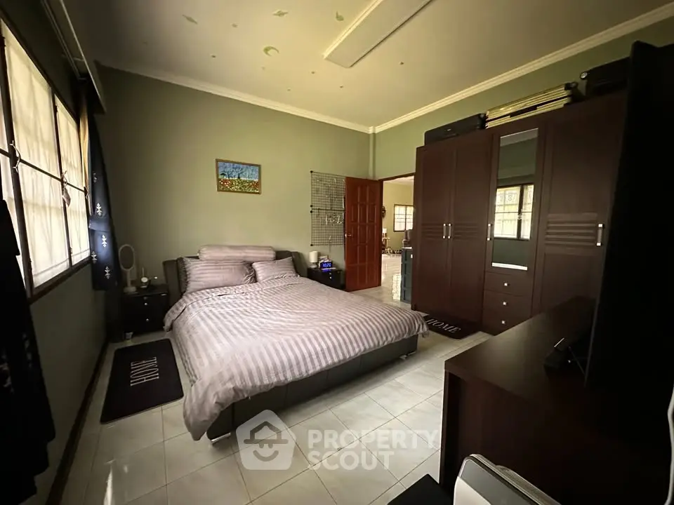 Spacious bedroom with modern decor and ample natural light