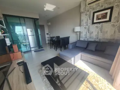 Modern living room with stylish decor and large windows offering natural light.