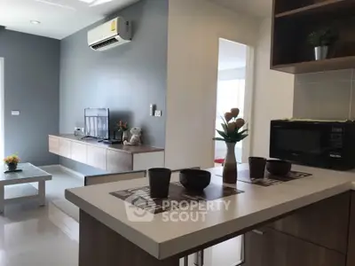 Modern living room with sleek furniture and air conditioning, open layout design.