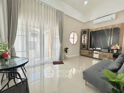 Elegant living room with modern decor, large windows, and stylish furniture, perfect for relaxation and entertaining.