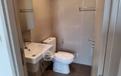 Modern bathroom with sleek fixtures and neutral tiles, perfect for a contemporary home.