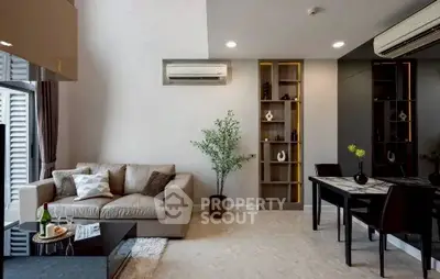 Modern living room with stylish decor and dining area, featuring air conditioning and elegant lighting.