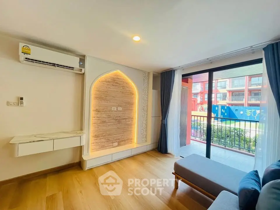 Modern living room with stylish lighting and balcony view in a contemporary apartment.