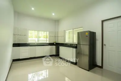 Modern kitchen with sleek design and stainless steel fridge
