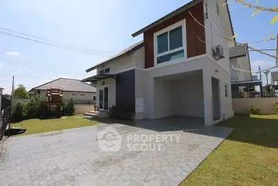 Modern two-story house with spacious driveway and lush green lawn