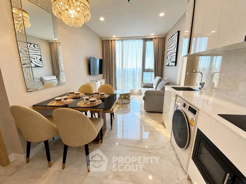 Luxurious open-plan living room and kitchen with elegant dining area and modern appliances.