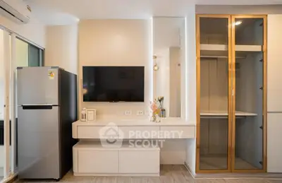 Modern living room with sleek TV setup and stylish storage solutions.