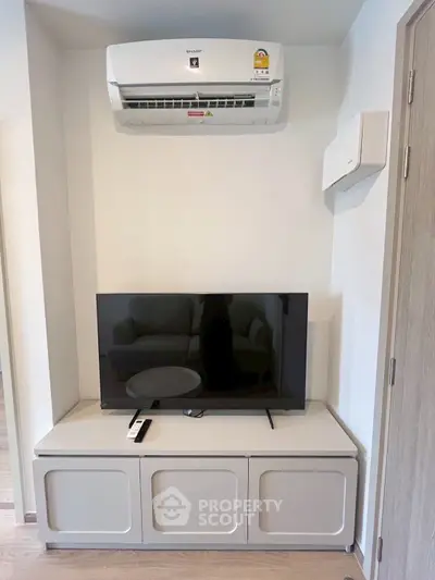 Modern living room with air conditioner and sleek TV setup