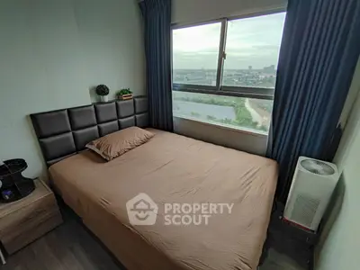 Cozy bedroom with a scenic view, featuring a comfortable bed and modern decor.