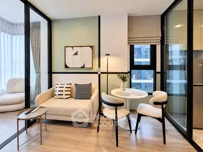 Modern living room with stylish decor and natural light in a contemporary apartment.