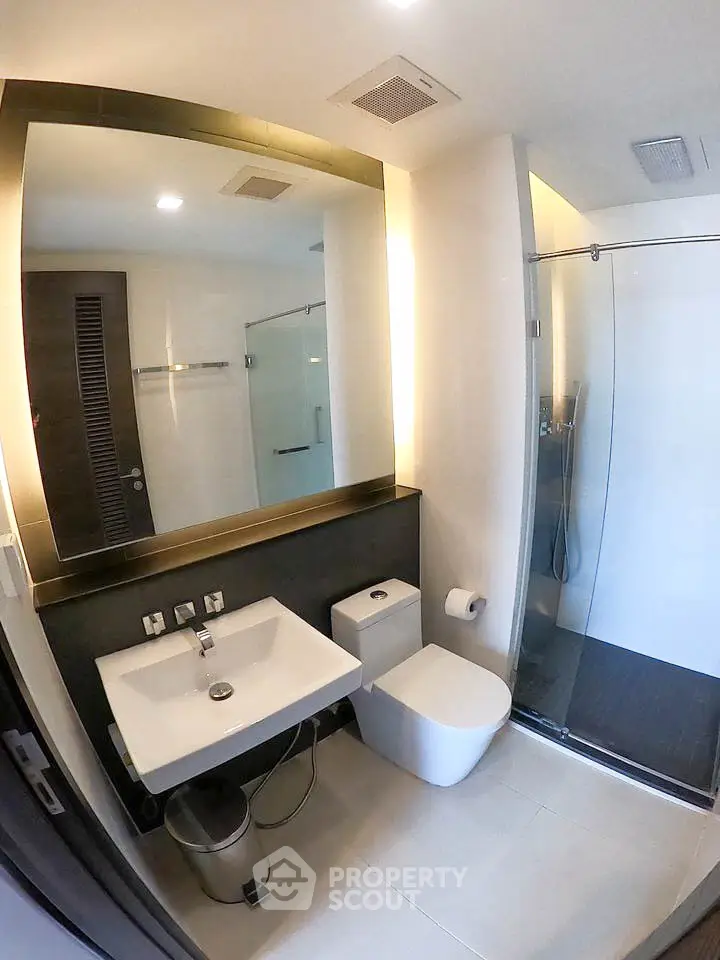 Modern bathroom with sleek fixtures and glass shower enclosure