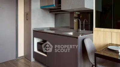 Modern compact kitchen with sleek cabinetry and integrated appliances in stylish apartment.