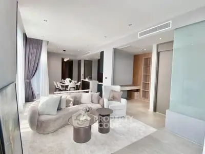 Luxurious modern living room with elegant decor and open dining area, perfect for stylish urban living.