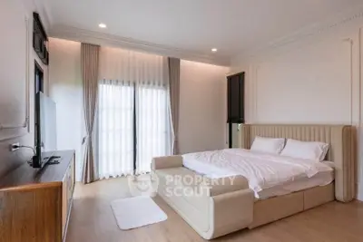 Luxurious bedroom with elegant decor and natural light, featuring a plush bed and stylish furnishings.