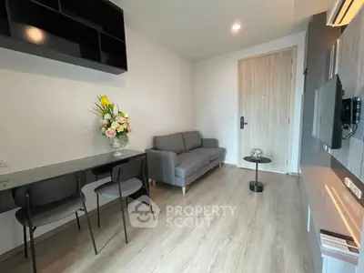 Modern living room with sleek furniture and elegant decor in a stylish apartment.