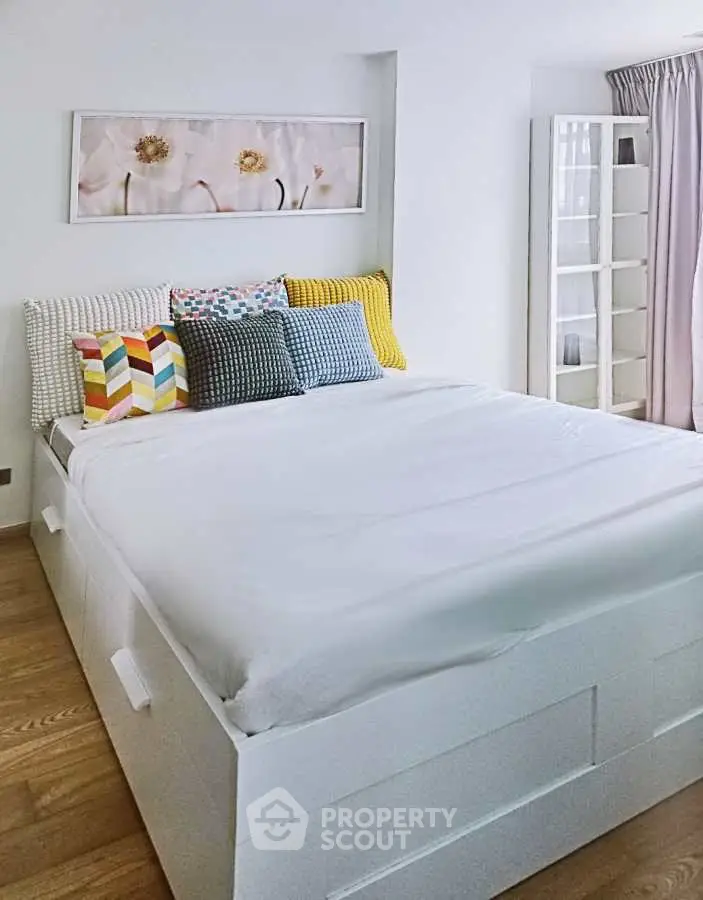 Cozy bedroom with stylish decor and ample natural light