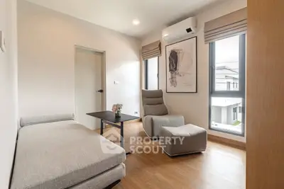Modern living room with stylish furniture and large windows offering natural light.