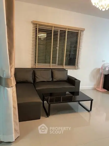 Modern living room with sleek sofa and glass coffee table, ideal for stylish urban living.