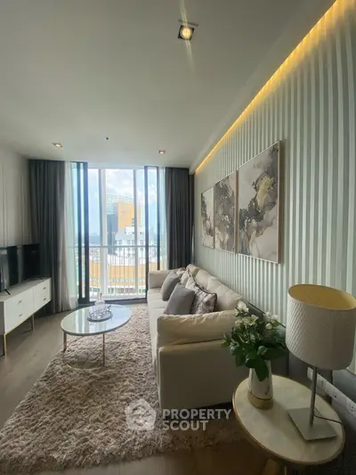 Stylish modern living room with large windows and elegant decor in urban apartment.