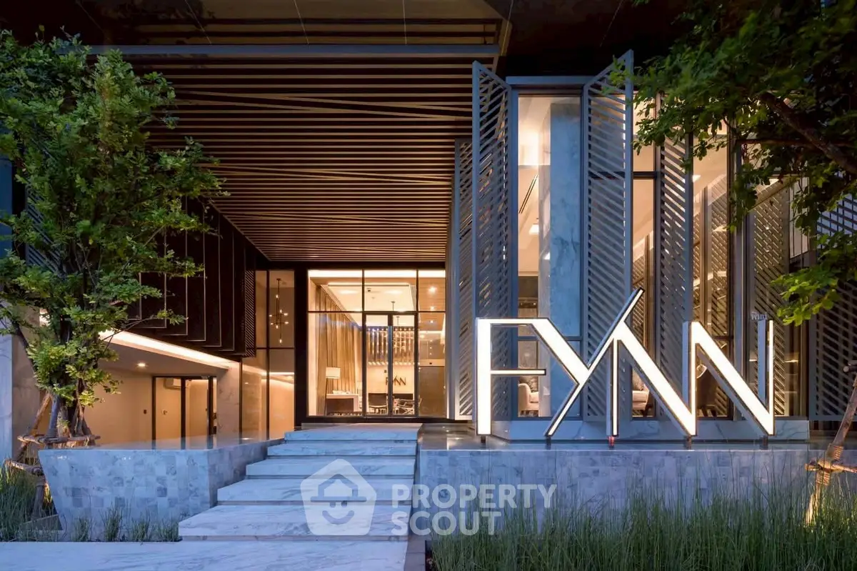 Luxurious modern building entrance with elegant design and ambient lighting.