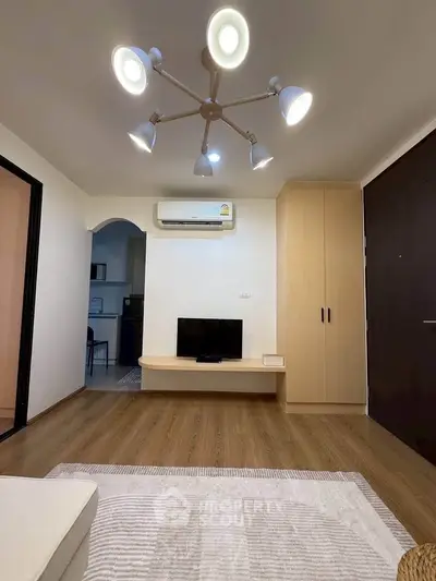 Modern living room with stylish lighting and wooden flooring