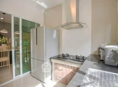 Modern kitchen with sleek appliances and open layout, featuring a gas stove and spacious dining area.