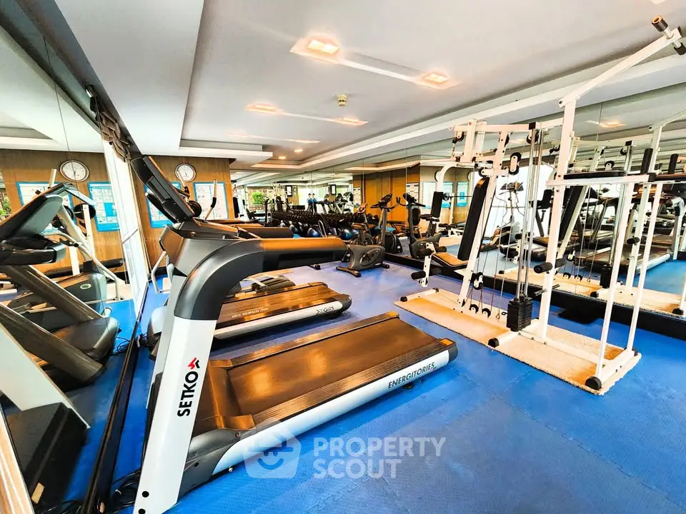 Modern gym with state-of-the-art fitness equipment and mirrored walls