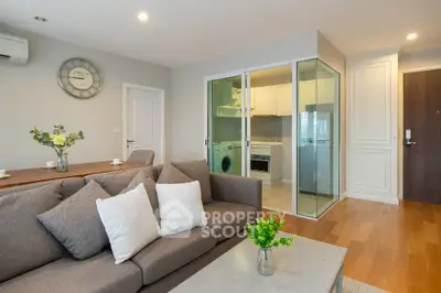 Modern living room with stylish decor and open kitchen layout in a cozy apartment.