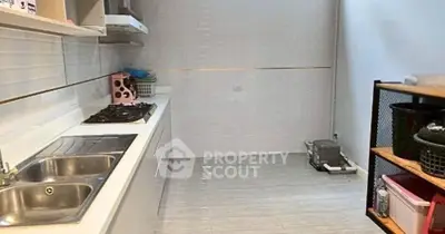 Modern kitchen with sleek white cabinetry and gas stove, perfect for culinary enthusiasts.