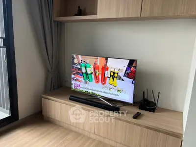 Modern living room with sleek TV setup and wooden cabinetry