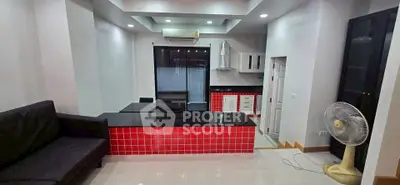 Modern kitchen with red tile accents and open layout