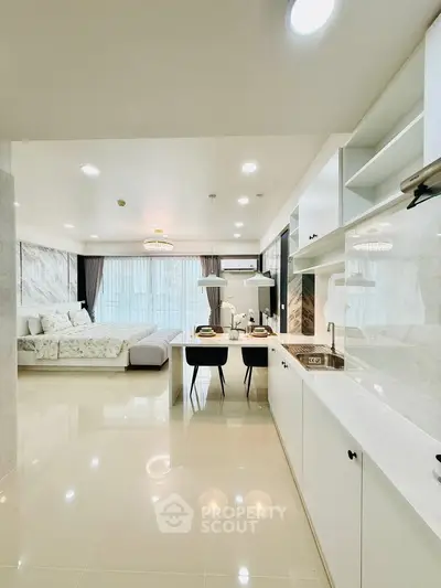 Spacious open-plan living room with modern kitchen and elegant dining area.