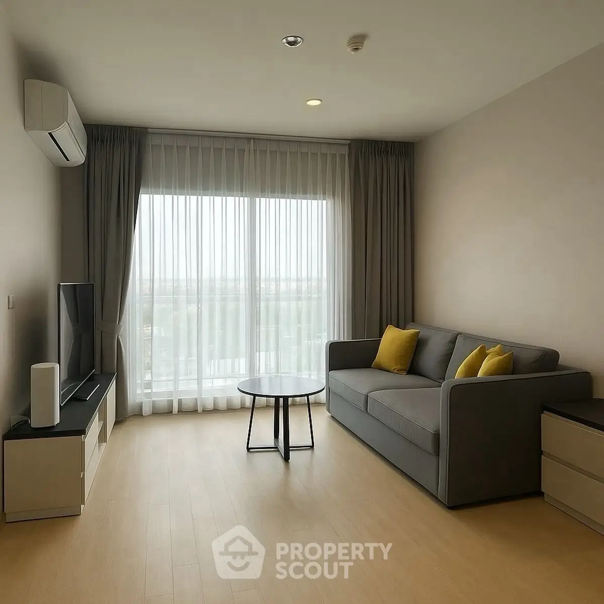 Modern living room with large window and cozy sofa, perfect for relaxation.