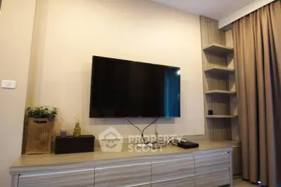 Modern living room with wall-mounted TV and stylish shelving unit