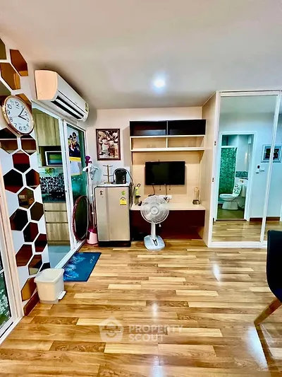 Modern living room with wooden flooring, air conditioning, and stylish decor in a cozy apartment.