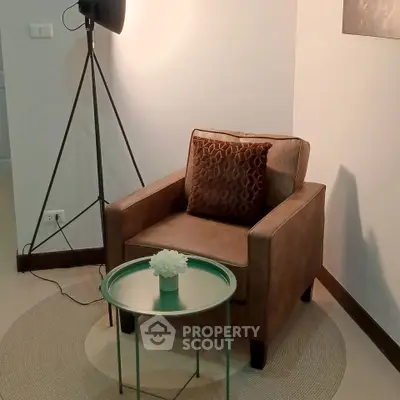 Cozy corner with stylish armchair and modern decor in a well-lit room.