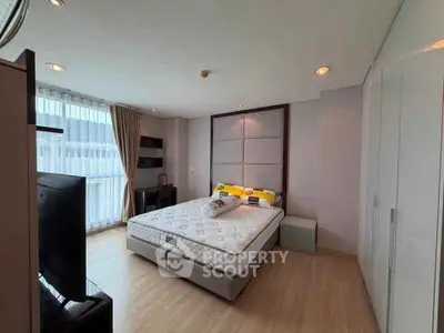 Spacious modern bedroom with large windows and elegant decor