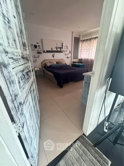 Charming bedroom with rustic door and cozy decor, perfect for relaxation and comfort.