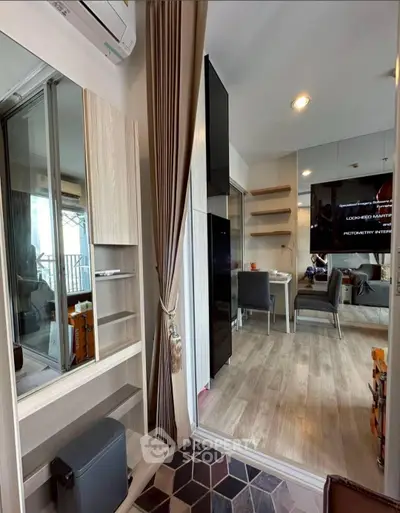 Modern apartment interior with stylish decor and open layout, featuring a cozy dining area and sleek shelving.