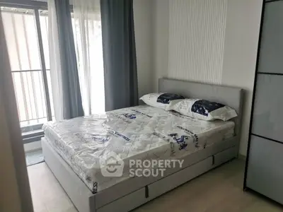 Modern bedroom with natural light and stylish decor in a contemporary apartment.
