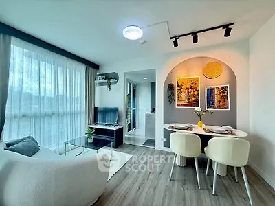 Modern living room with stylish decor and dining area in open layout apartment.