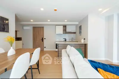 Modern open-plan living room with dining area and sleek kitchen design