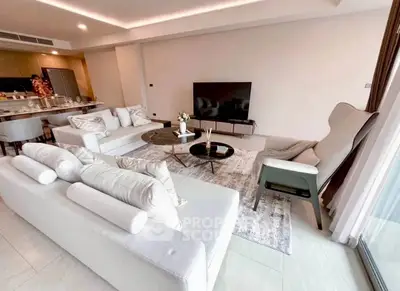 Spacious modern living room with elegant decor and open kitchen layout.