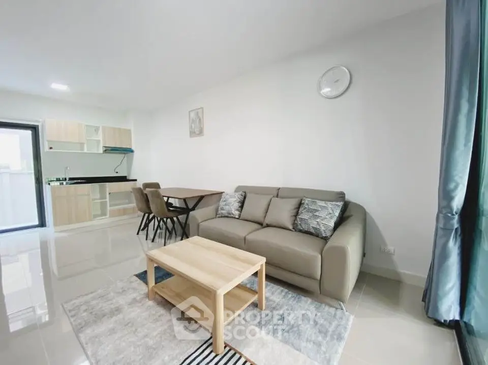 Modern living room with stylish furniture and open kitchen layout